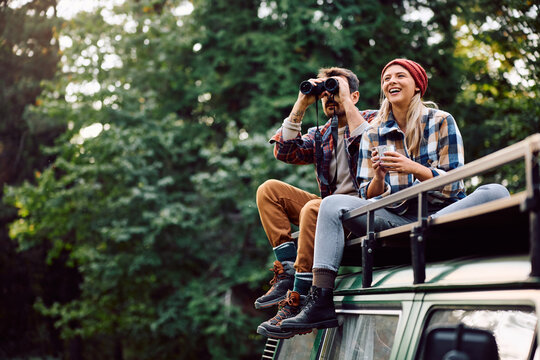 Happy couple of campers exploring the nature from their van. - Powered by Adobe