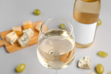 Glass of tasty wine on light background, closeup