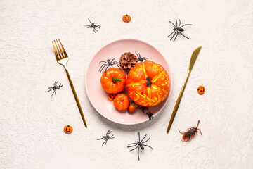 Halloween table setting with pumpkins and spiders on white grunge background