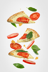 Falling slice of pizza with ingredients isolated