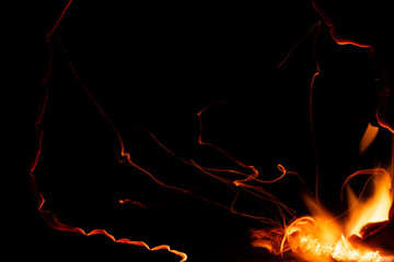 burning paper, glowing edge of paper on a black background