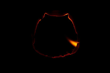 burning paper, glowing edge of paper on a black background