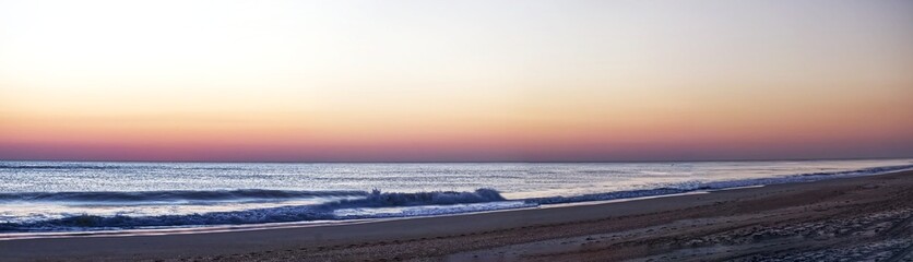 Panoramic view of the quiet early morning Outerbanks beach before sunrise, NC, USA