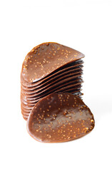 Stack of thin chocolate covered chips isolated on white background