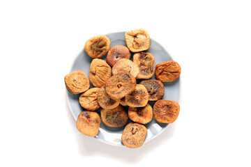 Plate with sweet dried figs on beige background