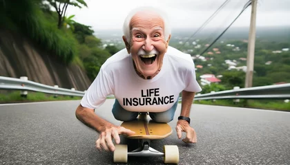 Poster Funny old man riding skateboard downhill wearing white shirt that says life insurance, active seniors concept  © Karlo