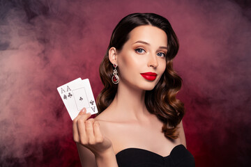 Photo of classy rich wealthy lady show two playing card winning poker combination over mist dark background