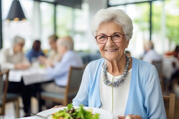 Senior woman in a retirement home, happily enjoying a healthy lunch