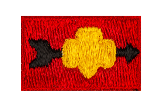 Close up of an isolated vintage red scouting badge of the scouting symbol and an arrow
