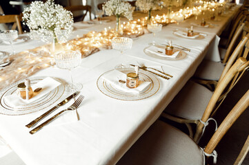 beautiful wedding tableware lies on a white table. gold spoons and forks. wedding decorations....