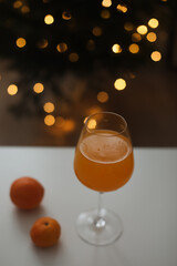 tangerine or orange juice with tangerines on the Christmas tree background