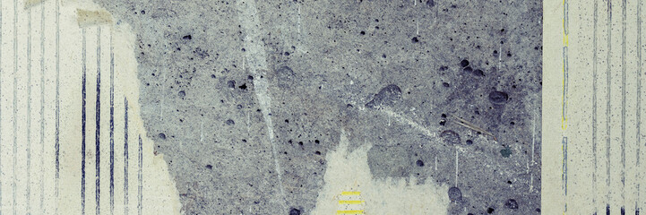 Torn old faded paper wallpaper with a retro pattern. Tattered scraps of paper on a concrete wall. Vintage texture for background and design. Closeup view with copy space.