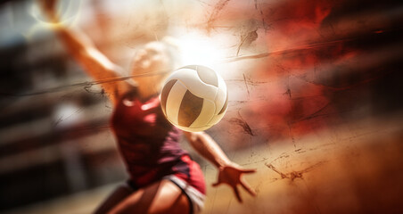 Dynamic image of a volleyball player with the ball during training - obrazy, fototapety, plakaty