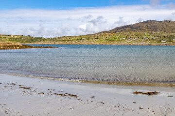 Beach with mountain and houses in background