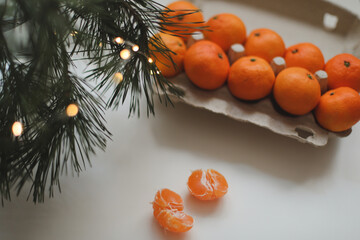 Christmas background with fir tree branches and tangerines. Merry Christmas and Happy New Year Greeting Card