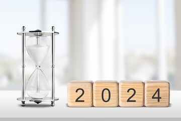 Flipping wooden block 2023 to 2024 concept with hourglass o
