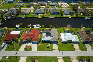 Damaged home rooftops after hurricane Ian in Florida coastal residential area. Consequences of...