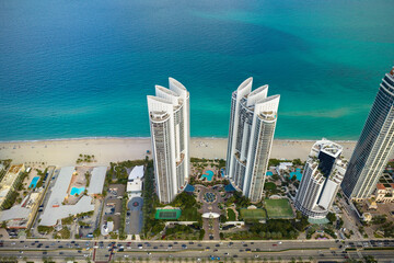Sunny Isles Beach city with luxurious highrise hotels and condo buildings on Atlantic ocean shore....