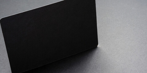 blank black card isolated on black background with shadow minimal conceptual 3d rendering 
