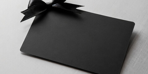 blank black gift business card with black ribbon bow isolated on white grey background with - obrazy, fototapety, plakaty