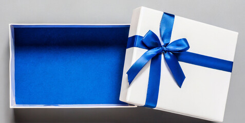 blank open white gift box with blue bottom inside or top view of opened blue present box wit