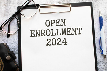 open enrollment 2024. text on a sticker next to money and banknotes,