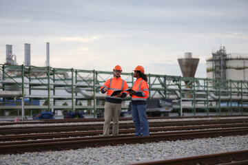 Railway Engineer with Orange safety jacket and helmet work audit