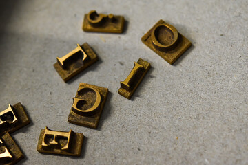 Antique printing press letters close-up metallic color