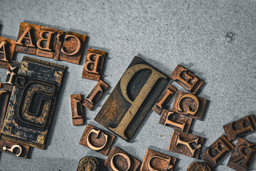 Antique printing press letters close-up metallic color