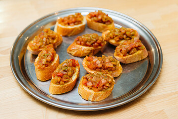 Bruschetta with Tomato and Basil. Tasty bruschetta with tomato sauce on a metal tray.