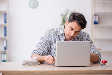 Young male employee working in the office