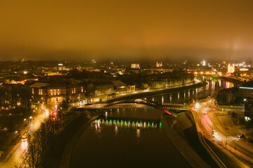 Fototapeta na wymiar Scenic aerial view of Vilnius Old Town and Neris river at nightfall. Sunset landscape.