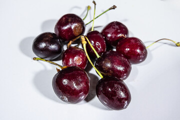 Selective blur on red cherries on a plate, in a studio shot. Cherries, also called prunus cerasus,is a berry also known as sour cherry.