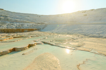 Bathed in soft glow of dawn, Pamukkale's thermal pools, UNESCO World Heritage Site nestled in...