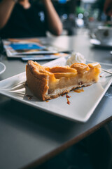A piece of apple pie or tart on a plate in a cafe - 664688856