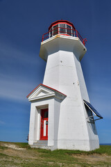 Forillon National Park red and white small lighthouse on sunny day with blue sky. Gasp&eacute; cape.