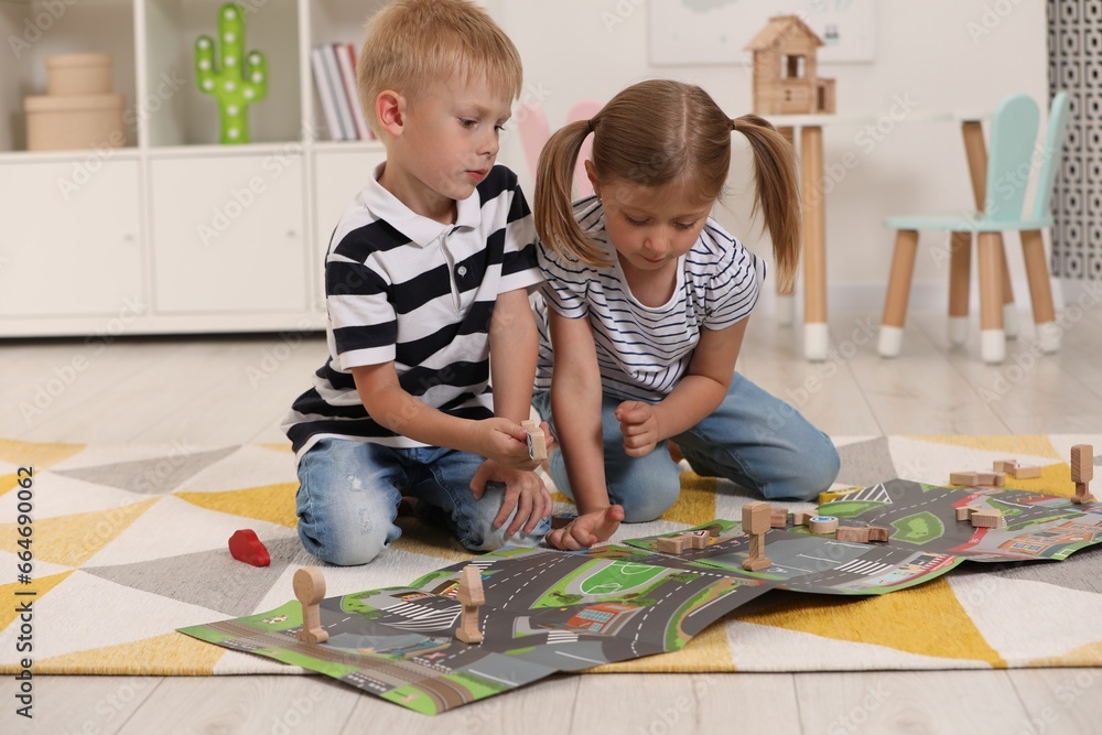 Sticker Little children playing with set of wooden road signs and toy cars indoors