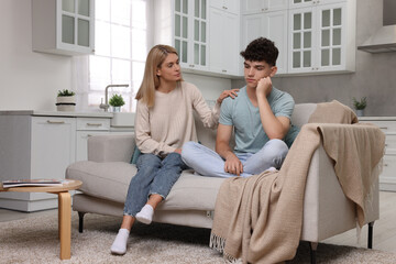 Obraz premium Mother consoling her upset son at home. Teenager problems