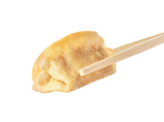 Chopsticks with delicious gyoza (asian dumpling) isolated on white