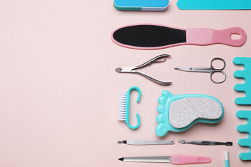 Set of pedicure tools on pink background, flat lay. Space for text