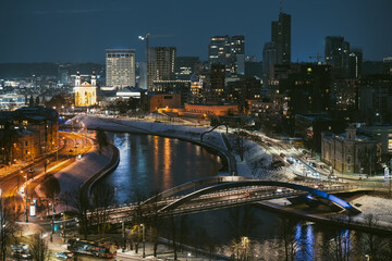 Beautiful aerial evening view of illuminated business district in Vilnius. Winter sunset in capital of Lithuania.