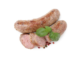 Tasty whole and cut homemade sausages, peppercorns and basil leaves isolated on white, top view