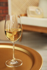 Glass of white wine on table in room, space for text. Relax at home