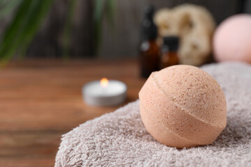 Beautiful aromatic bath bomb on towel, closeup. Space for text