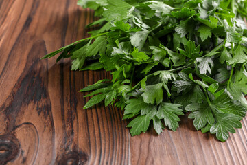 Bunch of fresh green parsley leaves on wooden table, closeup