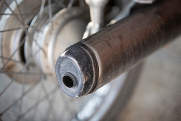 Close up of a motorcycle exhaust pipe. Selective focus with shallow depth of field.