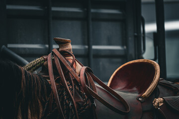closeup of western saddle on horse with brown leather
