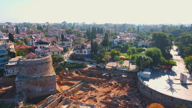 Enjoy a breathtaking view of Hidirlik Tower, an iconic symbol of Antalya's historical center, in this mesmerizing aerial stock video. The tower, with its ancient charm and stunning location