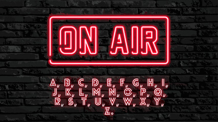On air sign red font with the alphabet on a dark brick background.