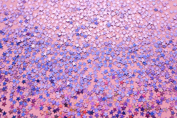 Purple sparkles on a pink background.